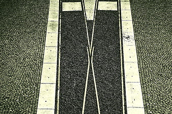 Top-down view of tram tracks on cobblestone street