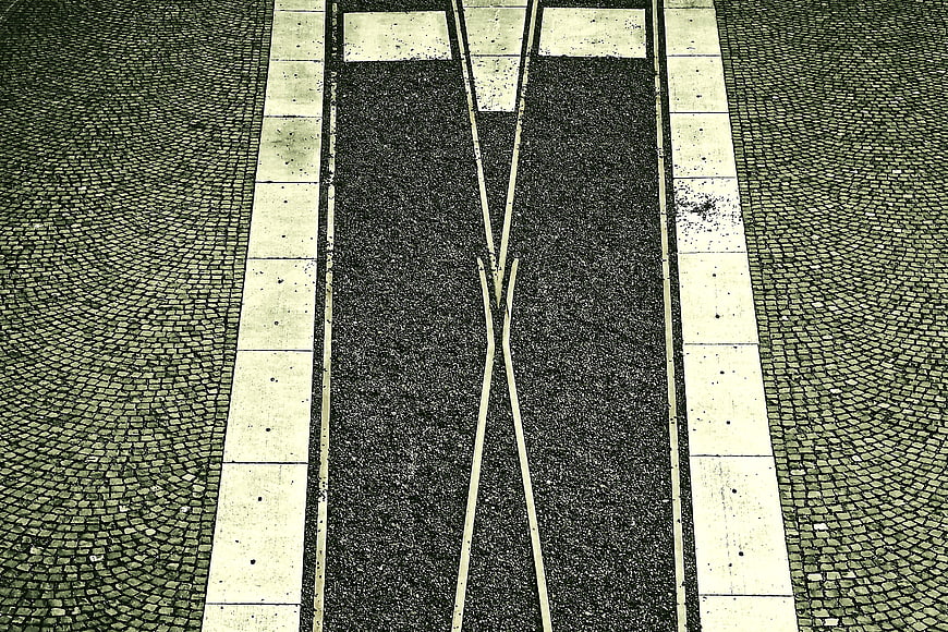 Top-down view of tram tracks on cobblestone street