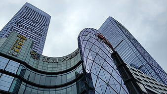 Low angle view of modern glass skyscrapers and commercial buildings