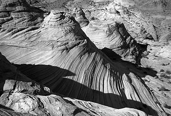 Black and white sandstone rock formations with dramatic shadows