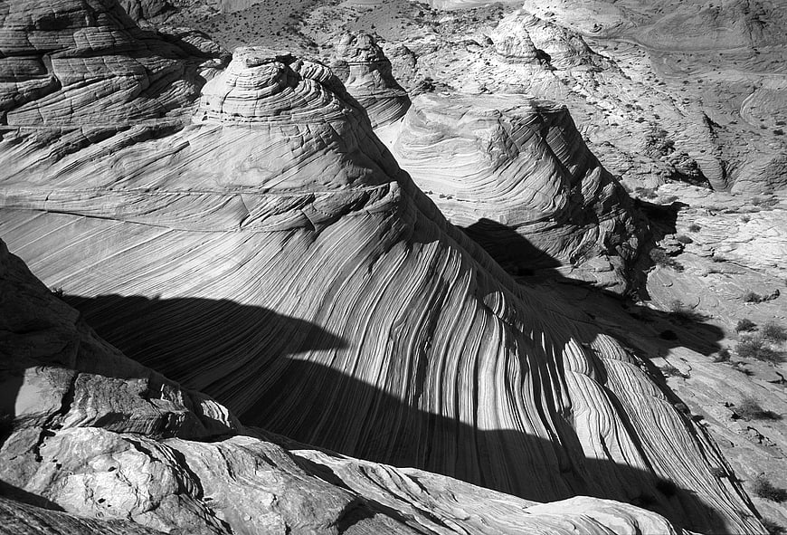 Black and white sandstone rock formations with dramatic shadows