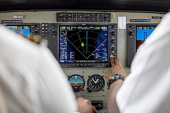 Pilot Hand Operating Flight Controls in Airplane Cockpit