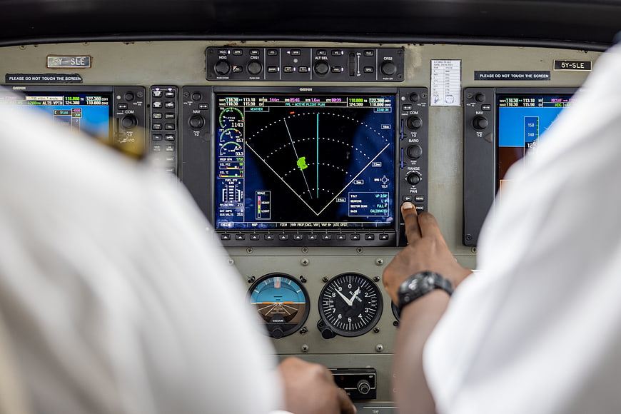 Pilot Hand Operating Flight Controls in Airplane Cockpit