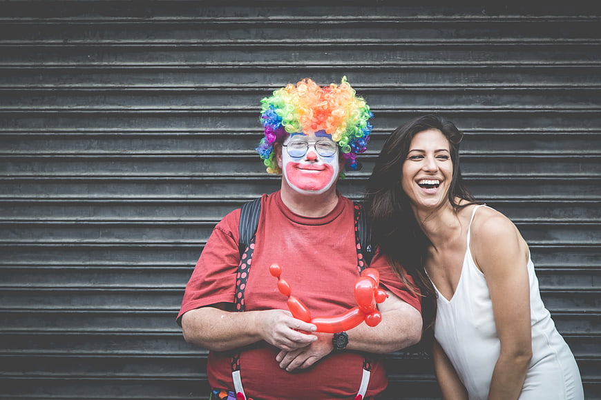 Happy Clown and Woman Laughing with Balloon Dog