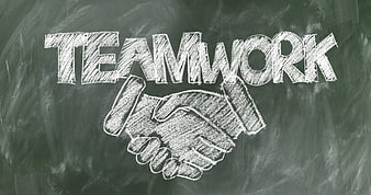 Teamwork chalk drawing with handshake on blackboard