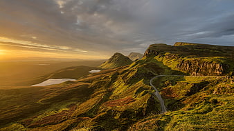 Winding Road Through Dramatic Highland Landscape at Sunset