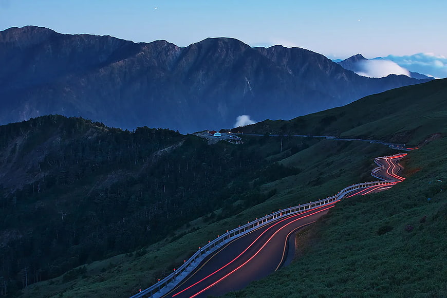 Long Exposure Winding Mountain Road with Red Light Trails