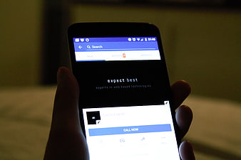 Hand holding smartphone displaying mobile app interface