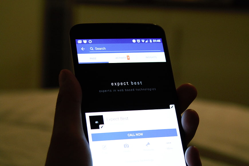 Hand holding smartphone displaying mobile app interface