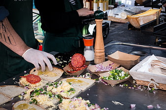 Chef preparing salami sandwiches at outdoor food market