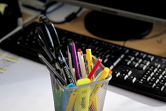 Mesh Office Pen Holder With Scissors And Markers On Desk