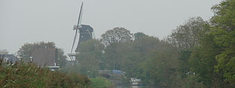 Traditional Dutch windmill in Winsum on a misty day
