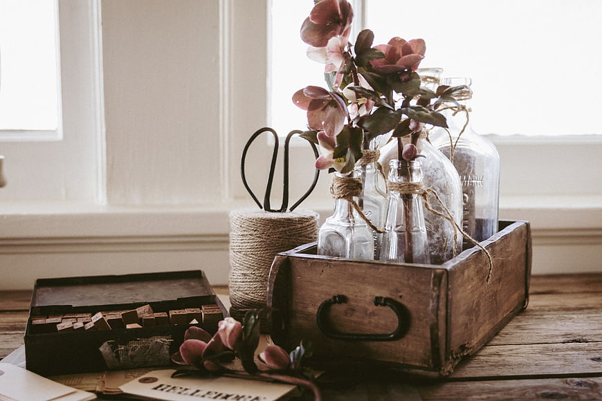 Rustic wooden crate with pink flowers and vintage letterpress blocks