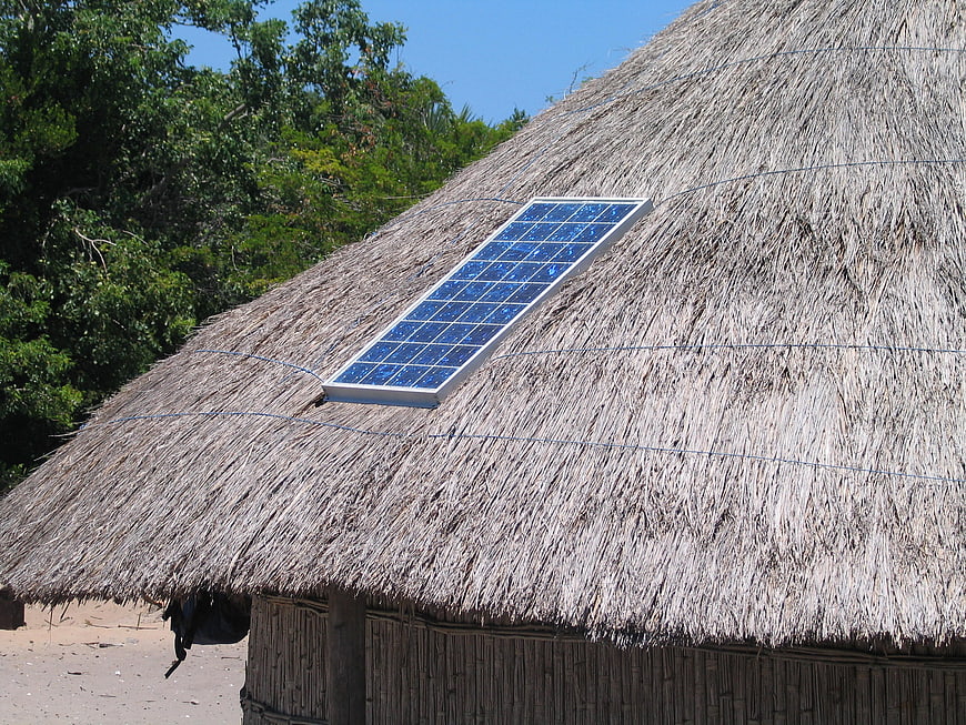 Solar panel on thatched roof of traditional hut