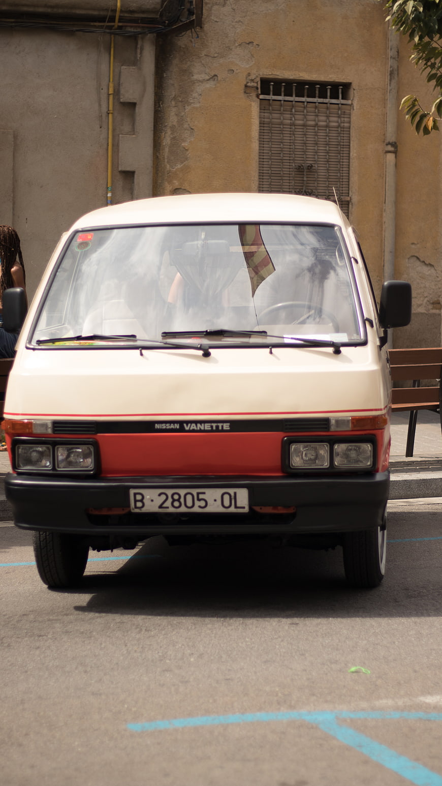 Vintage Nissan Vanette parked on a sunny street