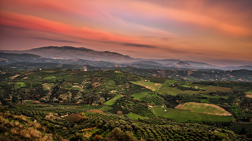 Rolling Hills Landscape with Dramatic Sunset Sky