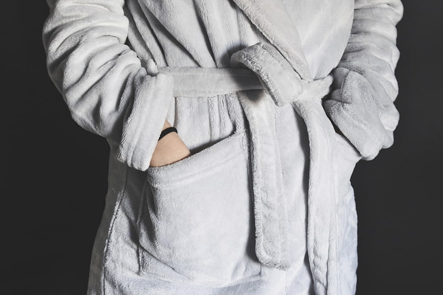 Person in White Plush Bathrobe with Hands in Pockets