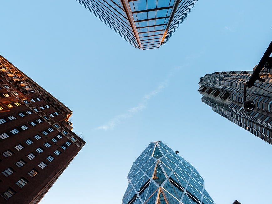 Low angle view of modern skyscrapers against blue sky