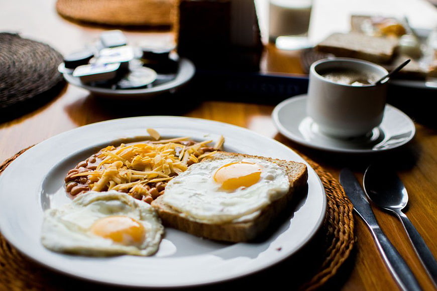 Hearty Breakfast with Fried Eggs, Beans, and Toast