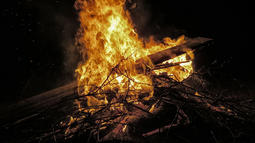 Intense Bonfire Burning Wood Planks and Twigs at Night