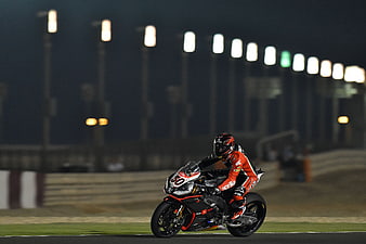 Motorcyclist Racing Superbike on Track at Night