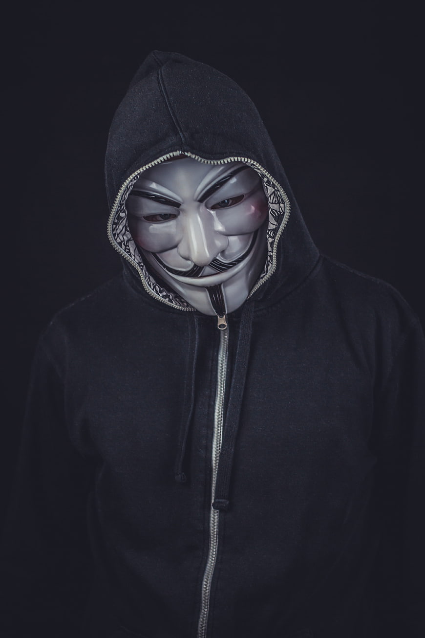 Anonymous Hacker in Black Hoodie and Guy Fawkes Mask