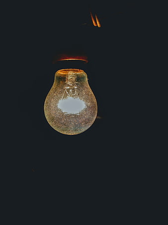 Vintage Light Bulb with Moon Reflection on Dark Background