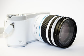 White Samsung NX300 Mirrorless Camera with Zoom Lens on White Background