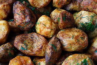 Close-up of roasted potatoes with fresh dill garnish