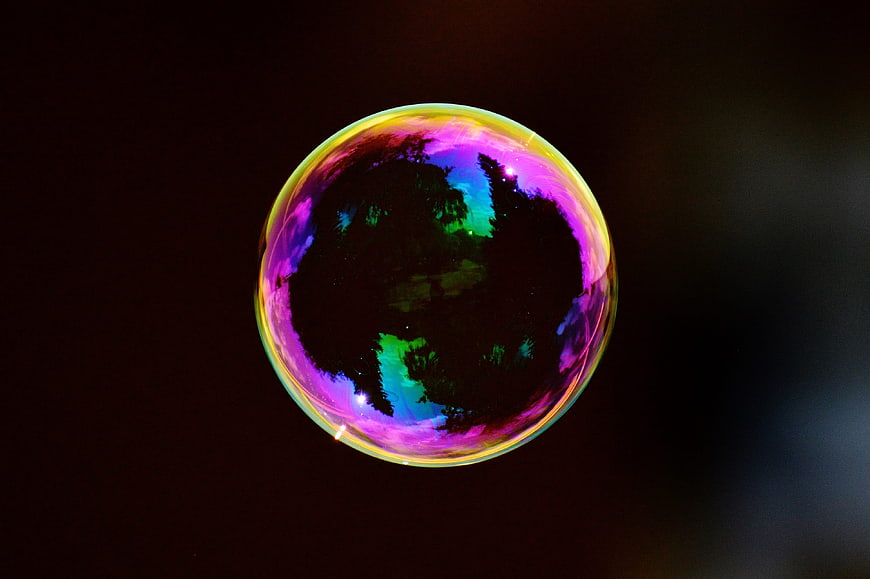 Colorful Soap Bubble with Iridescent Reflections on Dark Background