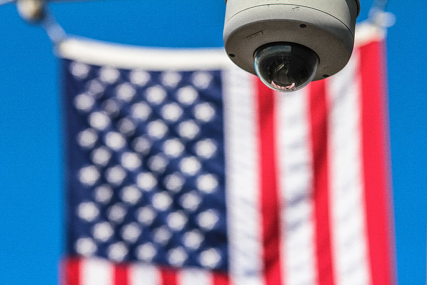 CCTV Security Camera with Blurred American Flag Background
