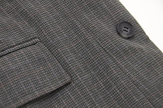 Close-up of Gray Plaid Suit Jacket Fabric and Button