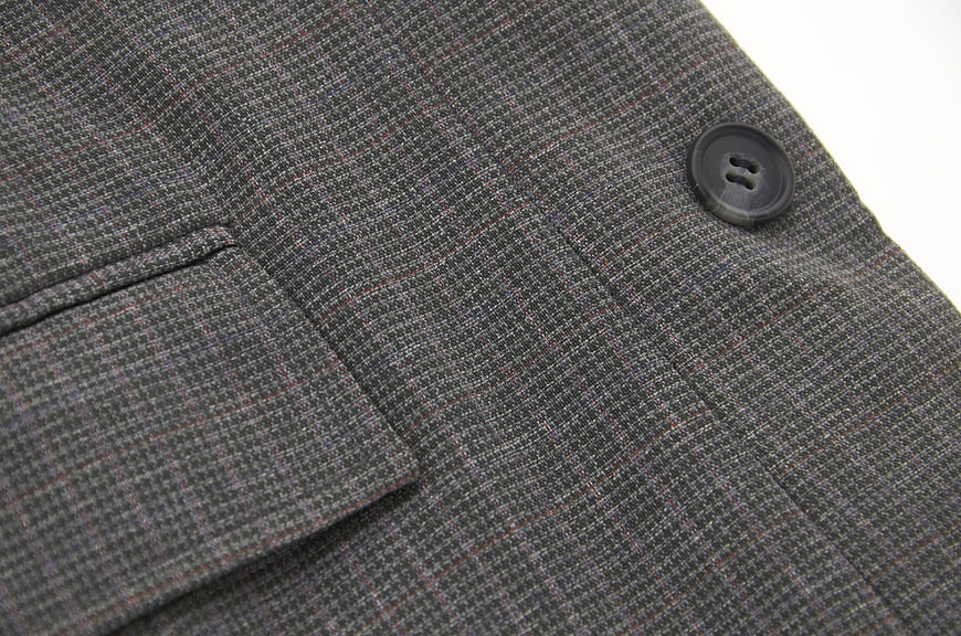 Close-up of Gray Plaid Suit Jacket Fabric and Button