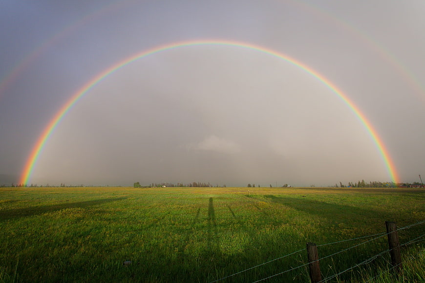 Double Rainbow Arching Over Green Pasture
