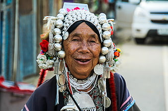 Portrait of smiling elderly Thai woman wearing traditional silver headdress
