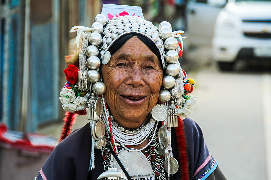 Portrait of smiling elderly Thai woman wearing traditional silver headdress