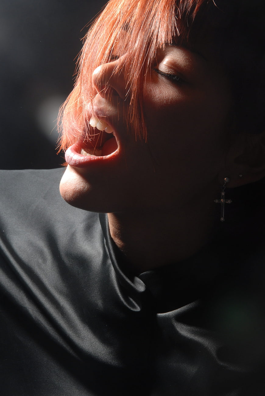 Dramatic Close-Up Portrait of Woman with Red Hair and Open Mouth
