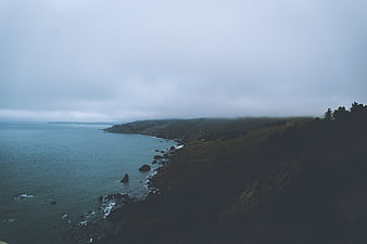 Misty Coastal Landscape with Ocean and Cliffs