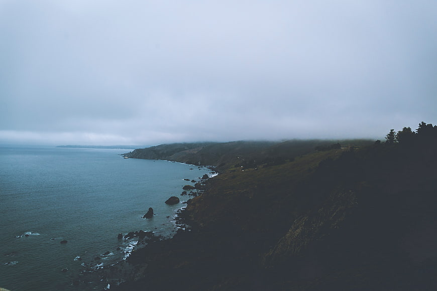 Misty Coastal Landscape with Ocean and Cliffs