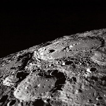 Black and white lunar surface with craters and shadows