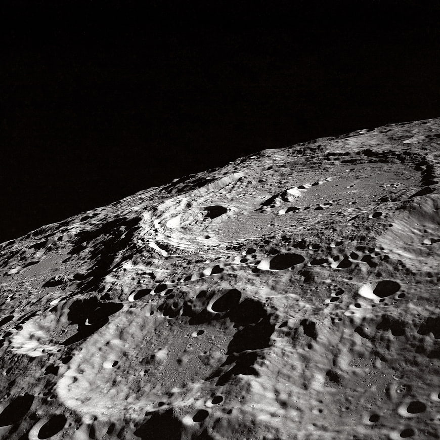 Black and white lunar surface with craters and shadows