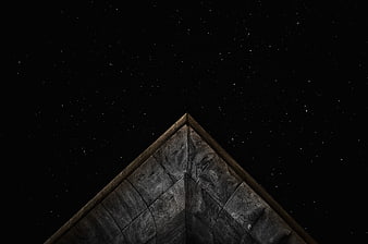 Starry Night Sky Above Geometric Stone Pyramid Roof