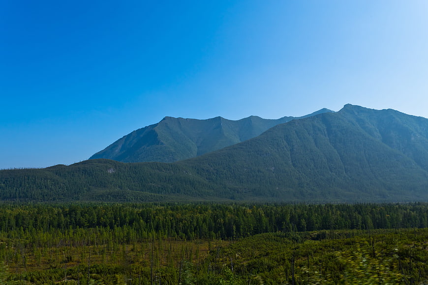 Scenic mountain landscape with forest and blue sky