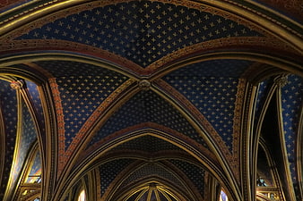 Gothic church ceiling with blue stars and gold arches