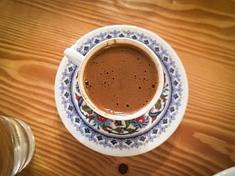 Top view of Turkish coffee in traditional cup on wooden table