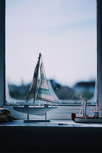 Model Sailboat on Windowsill with Frosted Glass Background