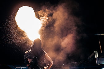 Fire Breather Performing at Night with Flames and Smoke