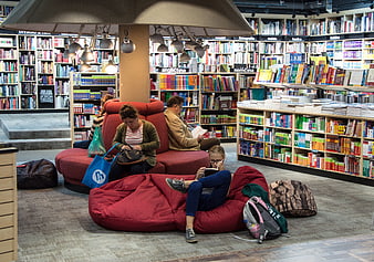 People Reading in Modern Bookstore with Red Bean Bags