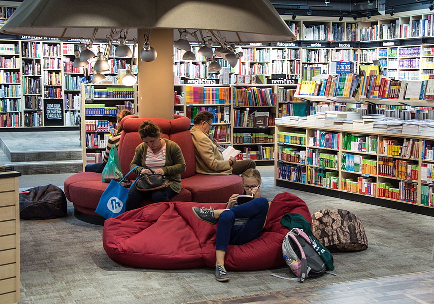 People Reading in Modern Bookstore with Red Bean Bags