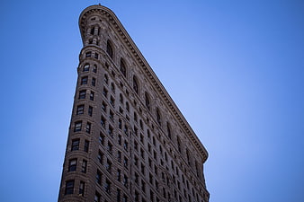Low angle view of Flatiron Building against blue sky